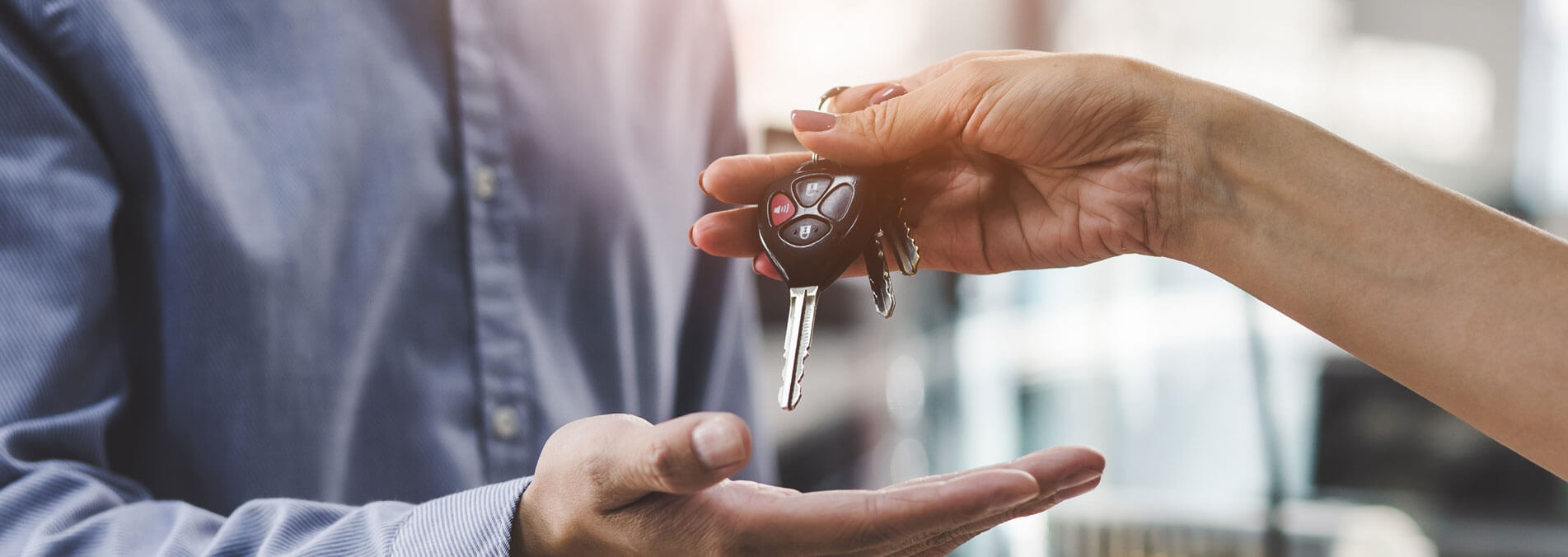 Person Handing Over Keys